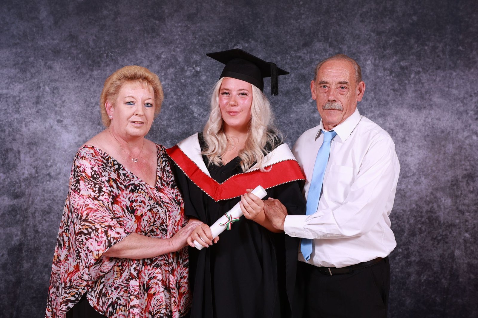 a family having a graduation portrait in a studio 
